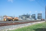 Two CCPN Switchers stands in front of the massive Corpus Christi Polymers LLC Plant